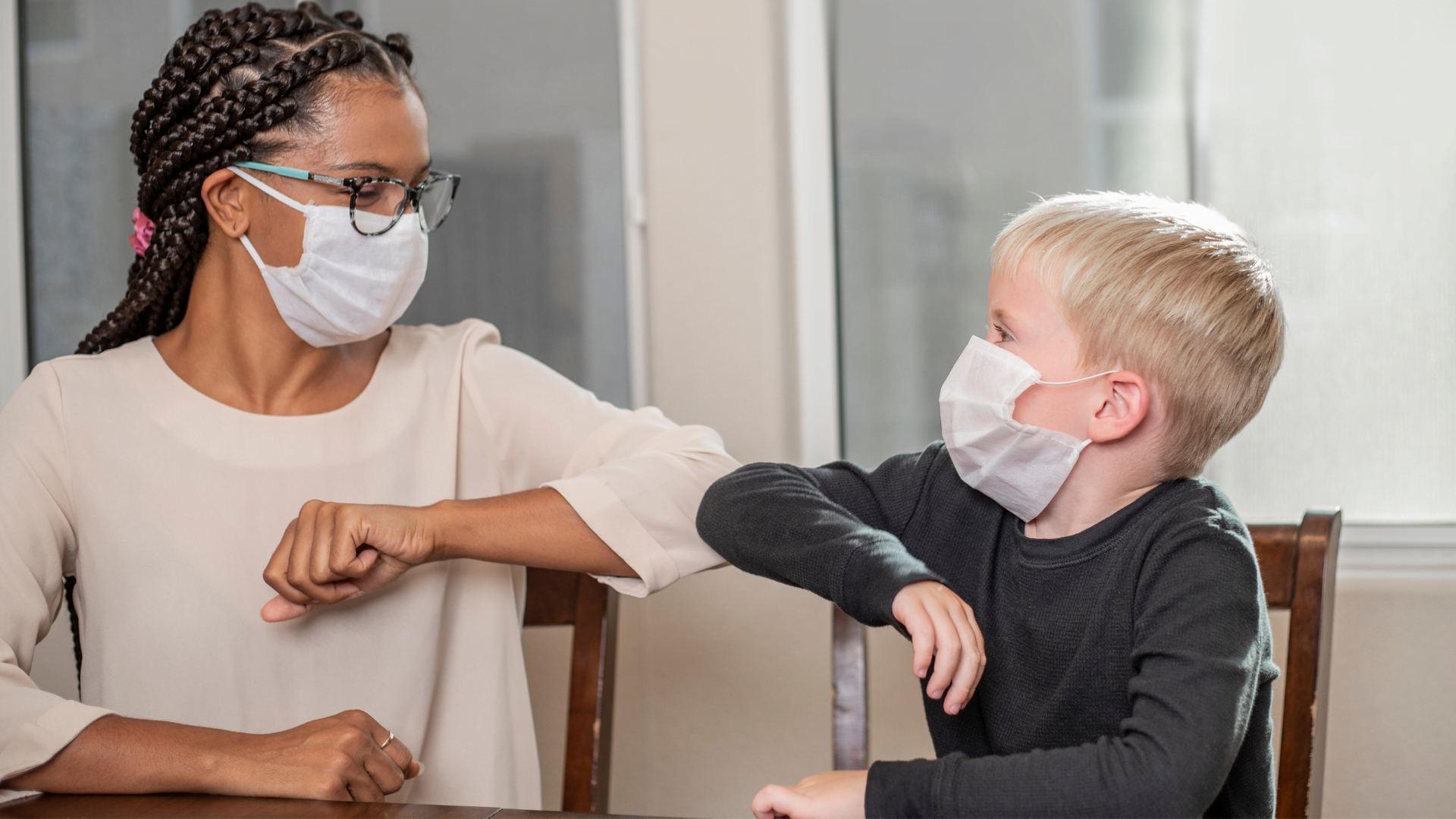 After School Program_Canva graphic_woman and kid masked elbow bump