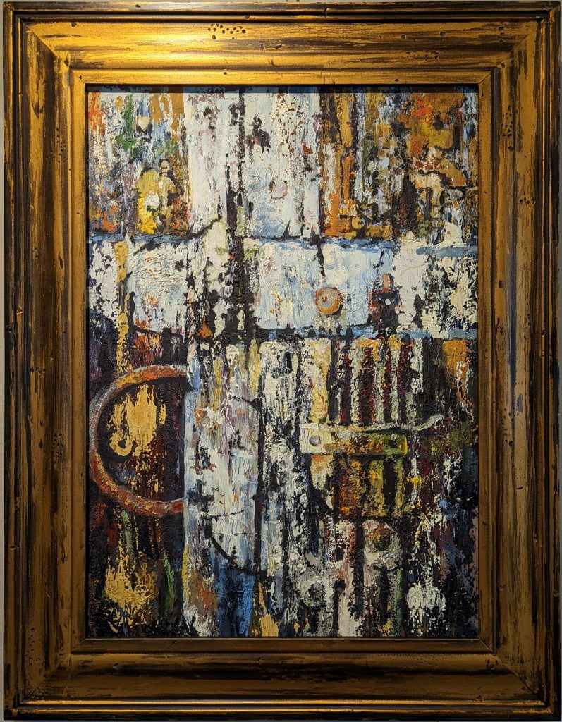 Cross to Bear by Jeanne Marston is an oil painting, framed in a brushed, antiqued gold and black frame. The painting depicts what appears to be an old farm door, made of deteriorating wood and rusted round-head screws. There is a rusted circular door pull partly revealed on the left side. The focus of the painting is the crossing of two door pieces which were at one point painted white and have chipped and faded some with time.