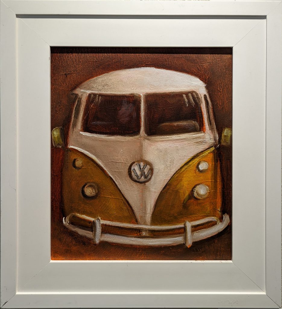 Vintage VW by Jeanne Marston is an oil painting in a matte and frame combo look white frame. We look head-on at a mustard yellow and white VW van, painted on a rusty red-brown background.